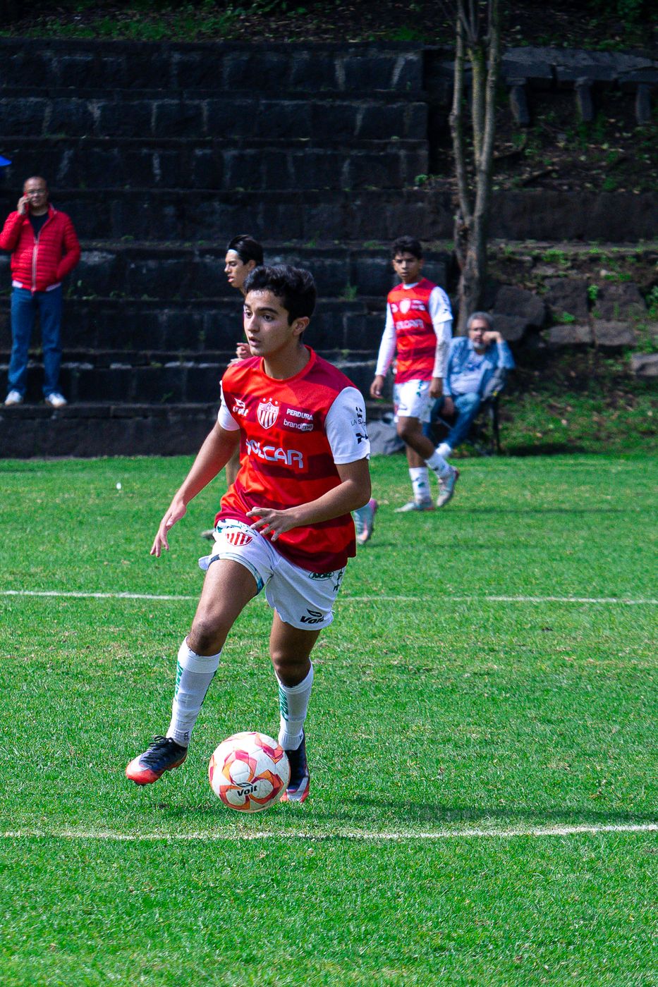 Jugador conduciendo el balón con la mirada al frente